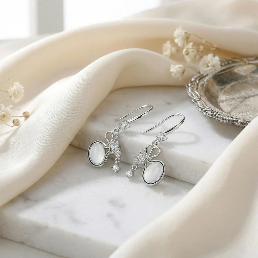 925 Sterling Silver Elegant Silver Bow Drop Earrings with Milky Moonstones and Sparkling Accents