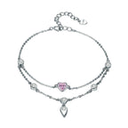 Silver bracelet with pink heart charm on a white background