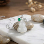 925 Sterling Silver Elegant Translucent White Hulu Pendant Necklace with Emerald and Diamond Accents NP Collection